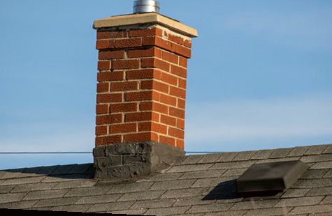 Brick chimney crown and vent collar checked for leaks
